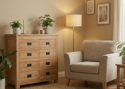 Gezellige woonkamer met teak ladekast Bumi, fauteuil, vloerlamp en planten op vloerkleed.